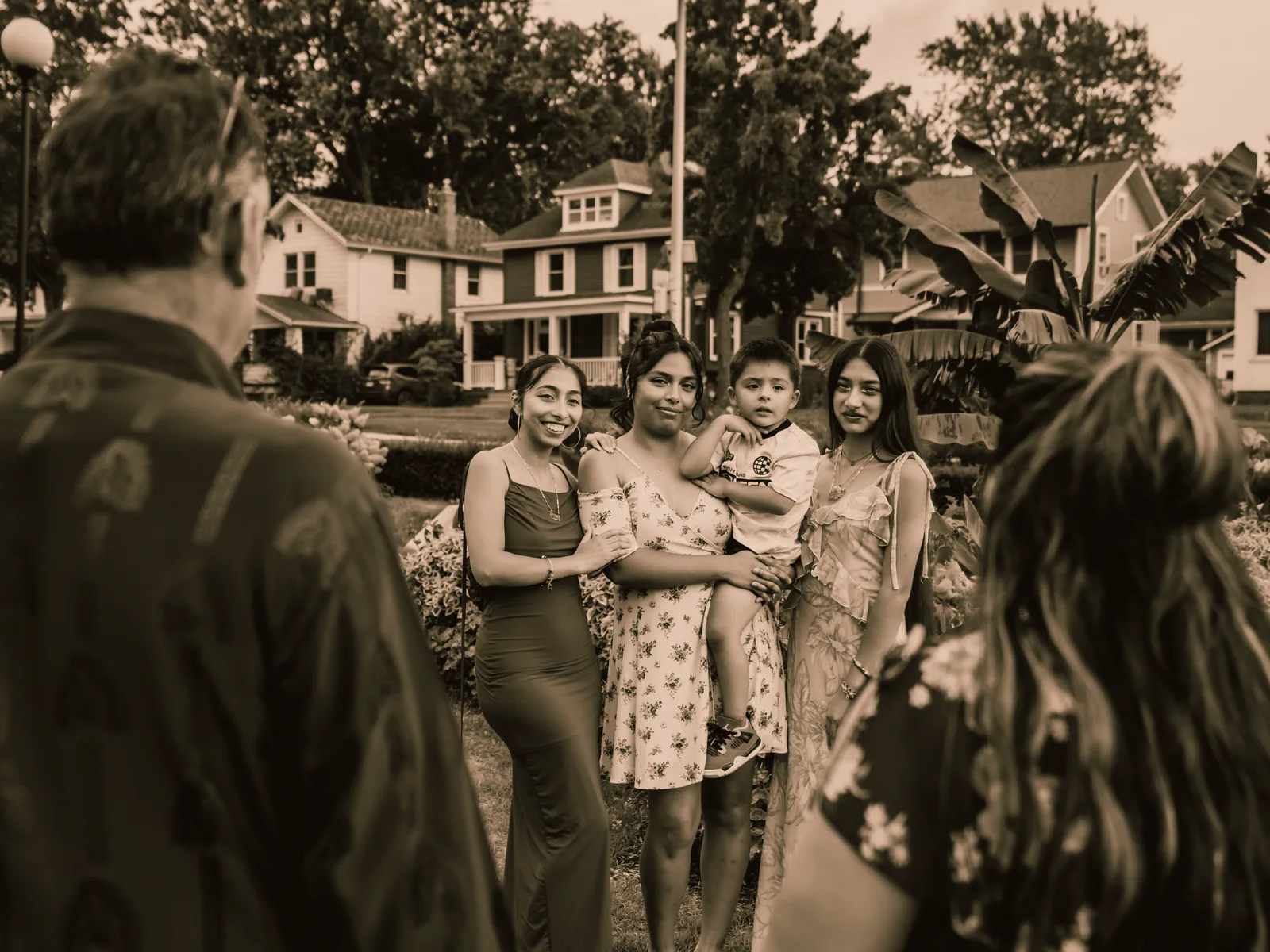 The family gathered close, smiling at one another