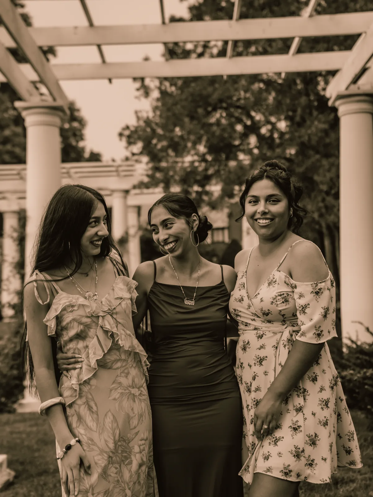A toned portrait of the three sisters beneath the pergola