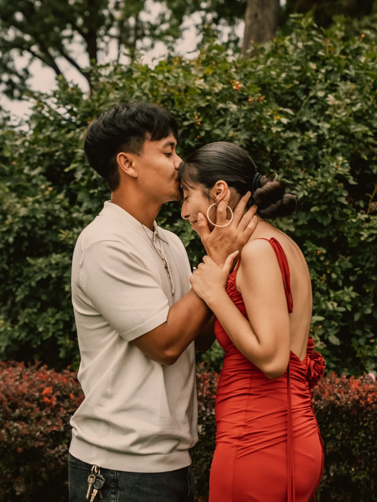 He kisses her forehead as she smiles