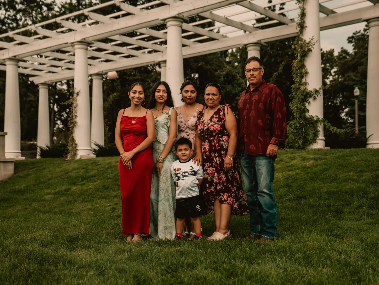 The whole family gathered on the lawn beneath the pergola