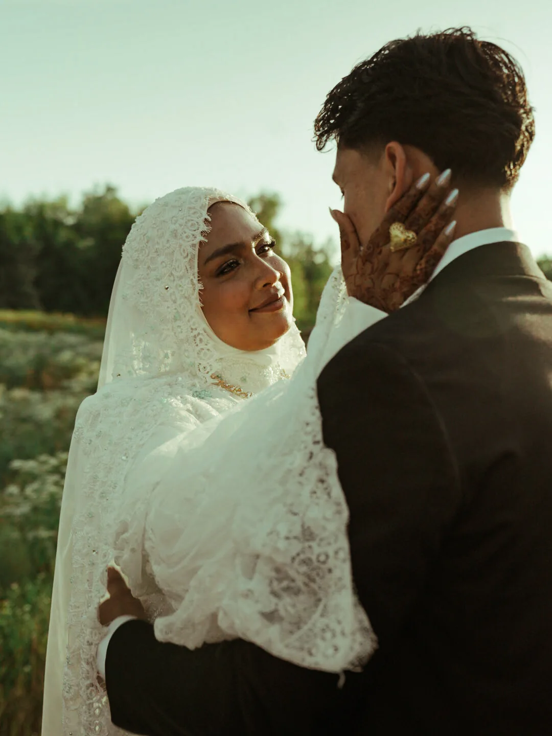 A newlywed couple sharing a close moment outdoors